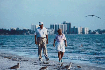 Older couple walking on the beach